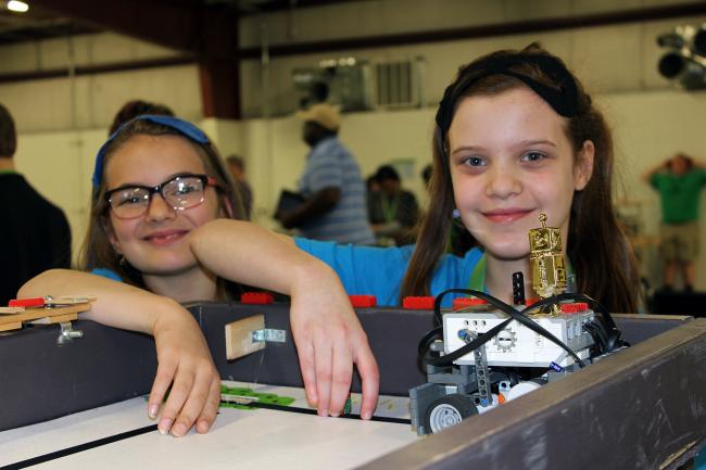 2 girls with a robot they built