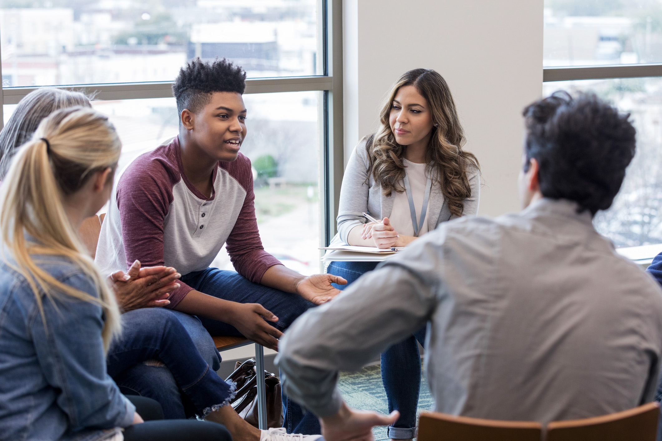 teenage boy speaking to group