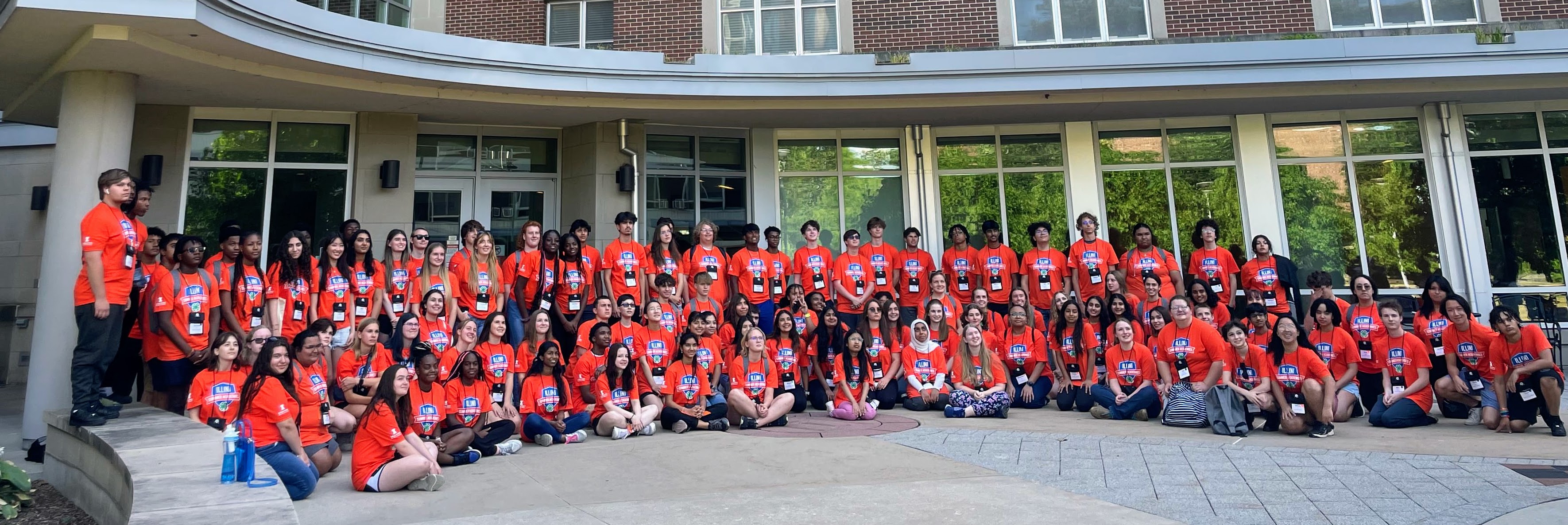 A group photo of high school student participants in Illinois 4H's Illinois Summer Academies program wearing matching orange shirts.