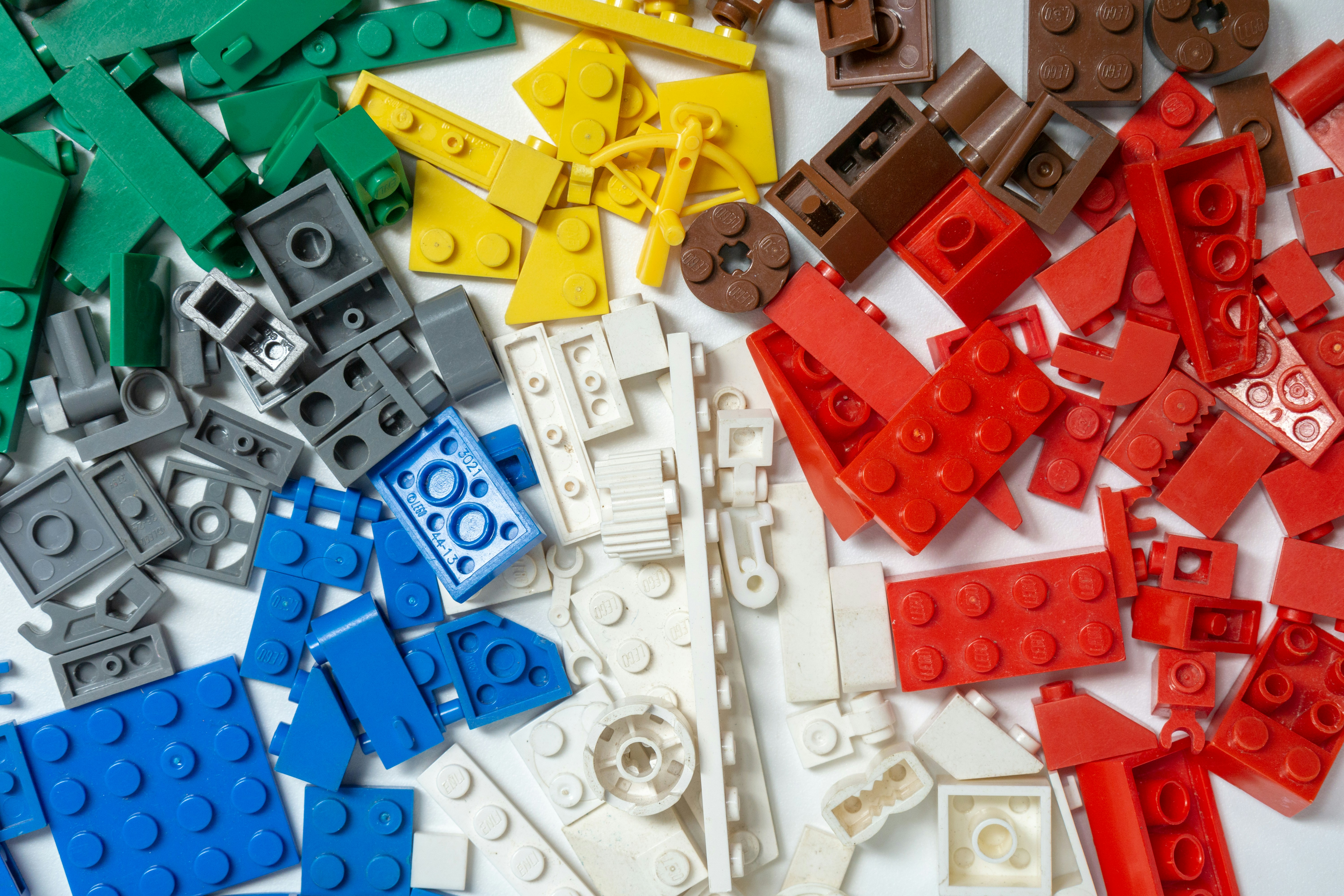 piles of plastic building bricks grouped by color