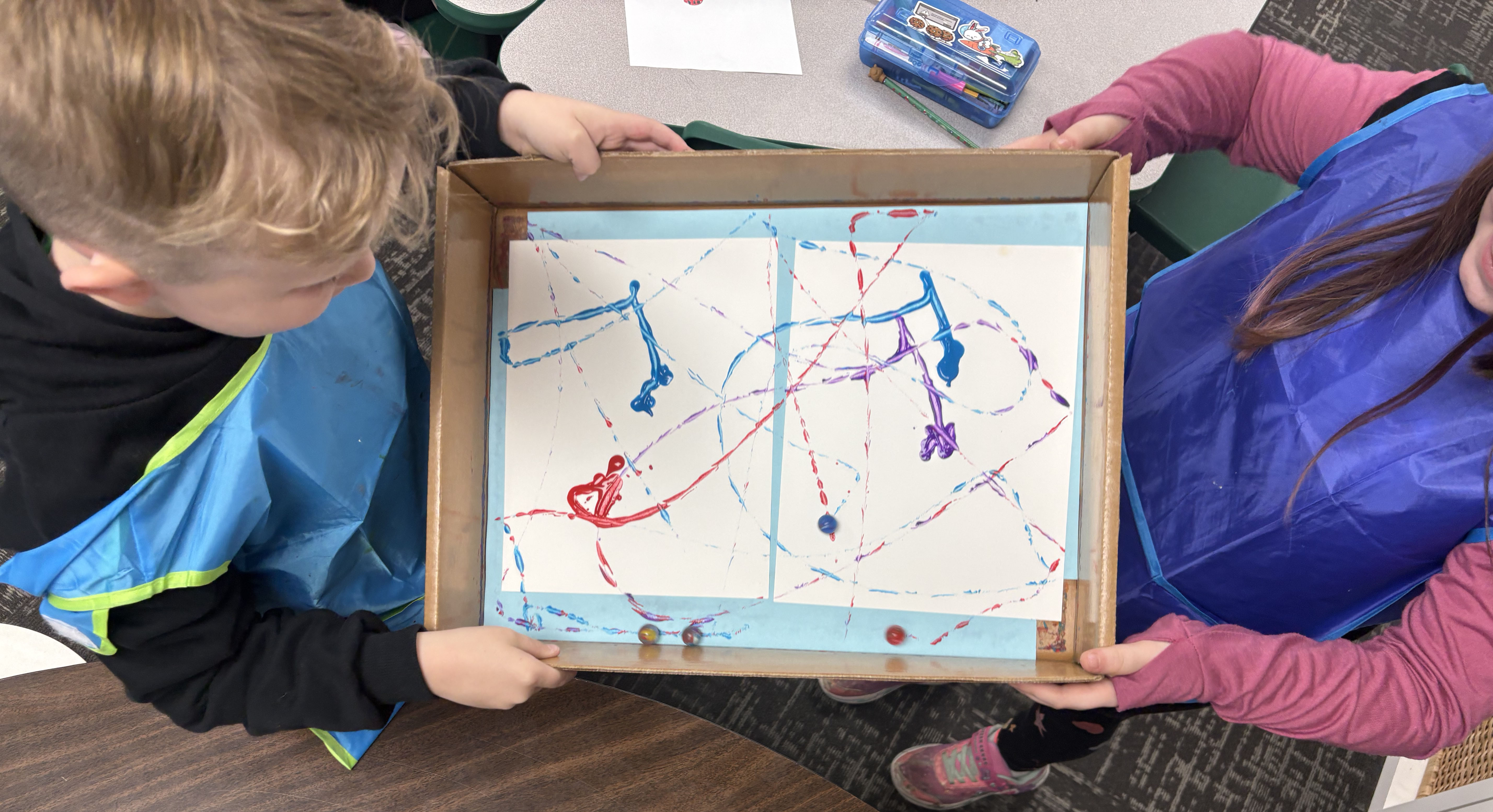 Two youth creating a marble painting