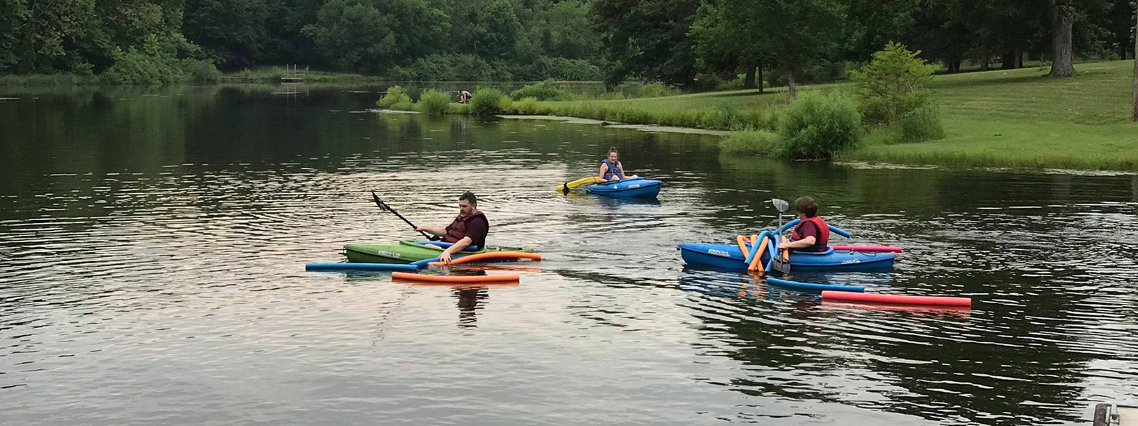 family kayaking in lake