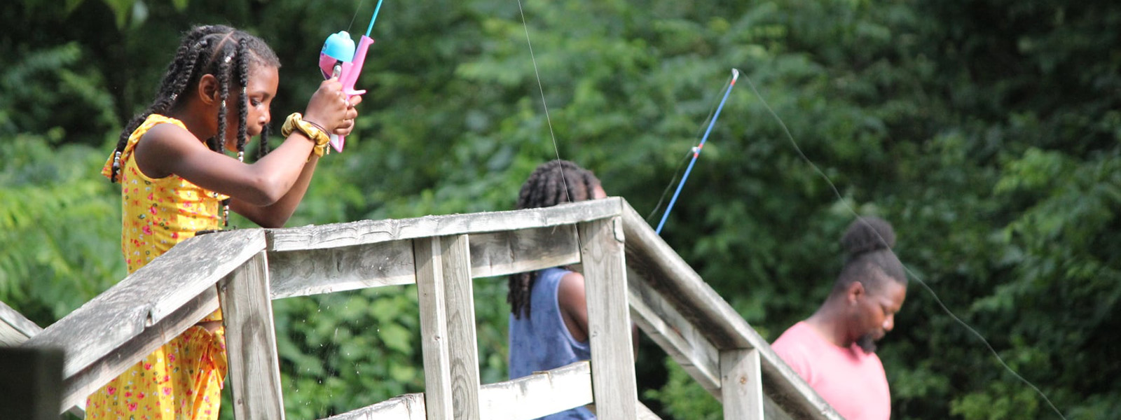 girls fishing off dock