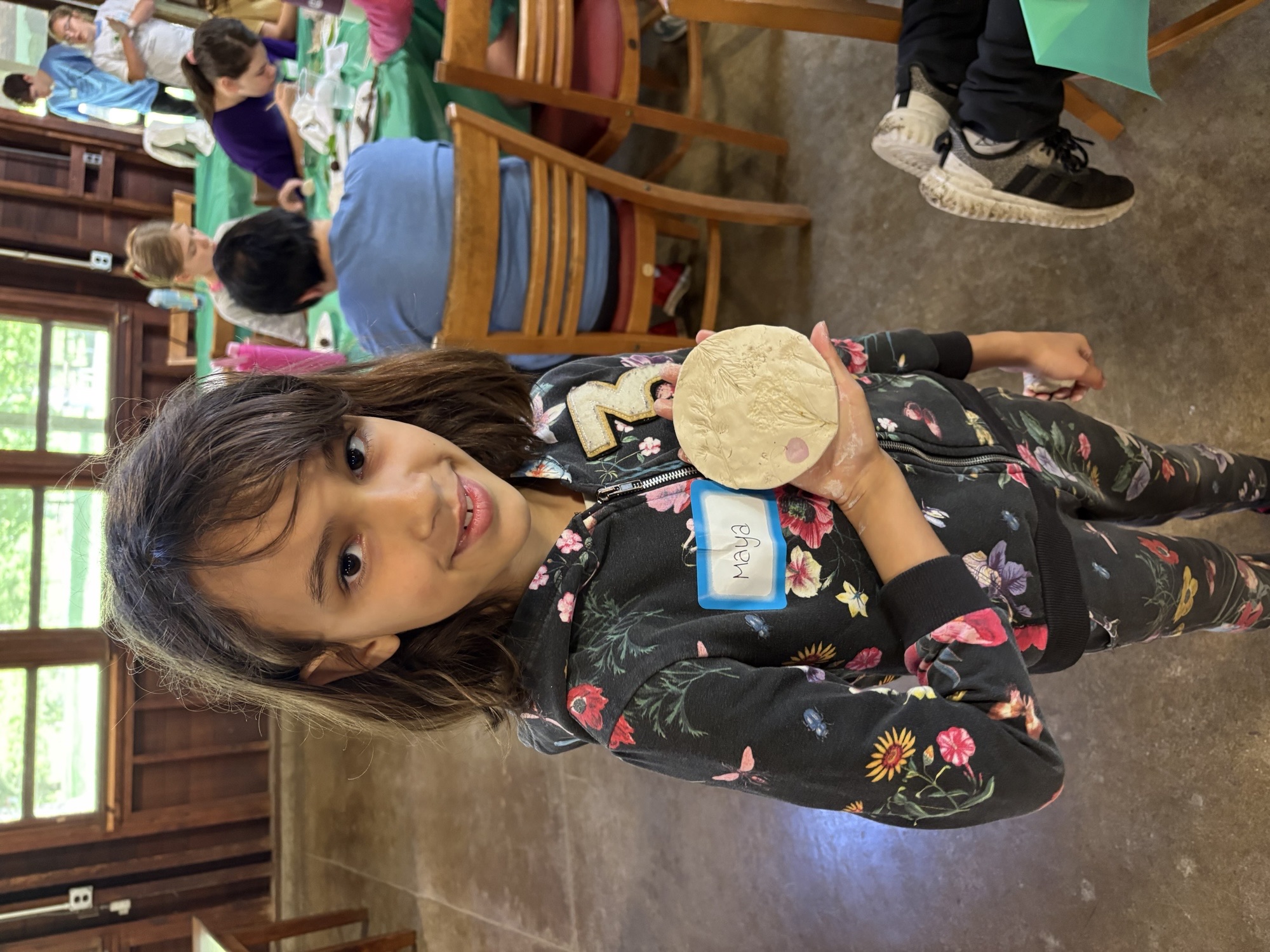 Youth holding clay impression