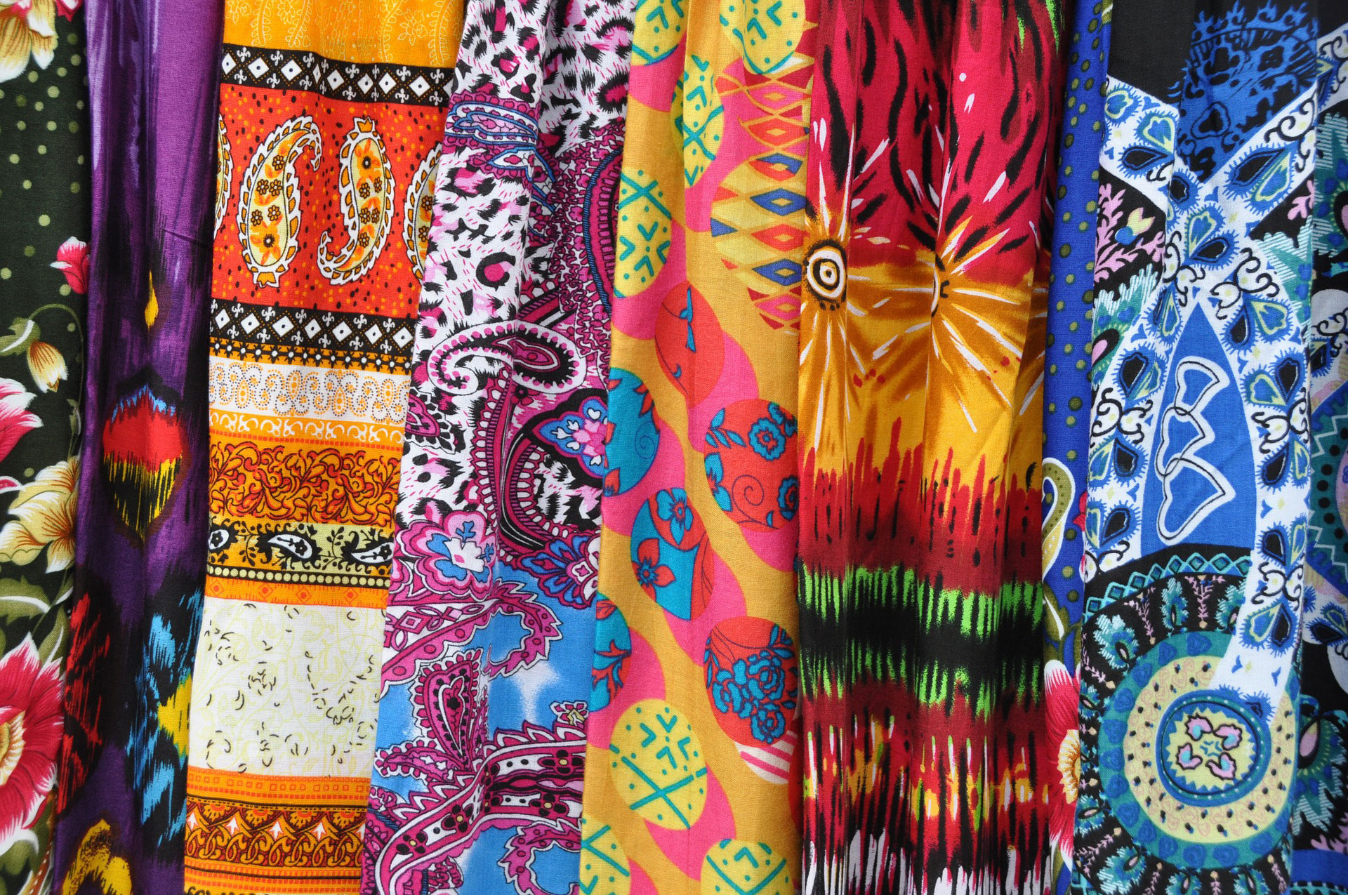 variety of fabrics with bright patterns on them