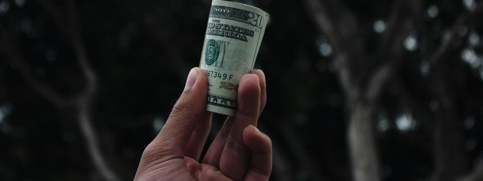 hand holding $20 bill