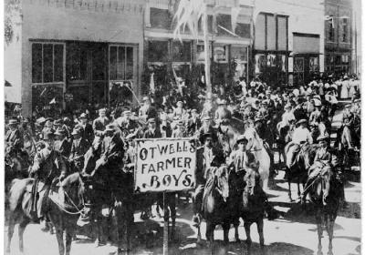 Group of boys on horseback with a sign Otwells Farmer Boys