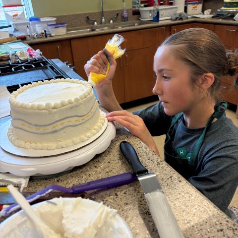 Youth decorating a cake