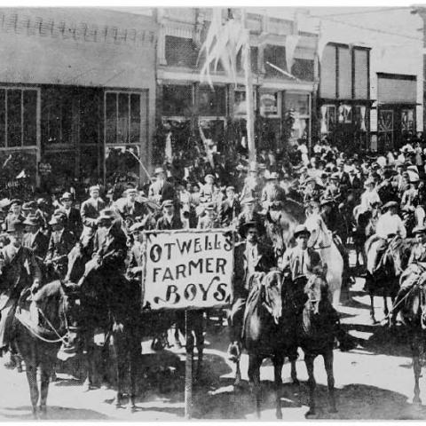 Group of boys on horseback with a sign Otwells Farmer Boys