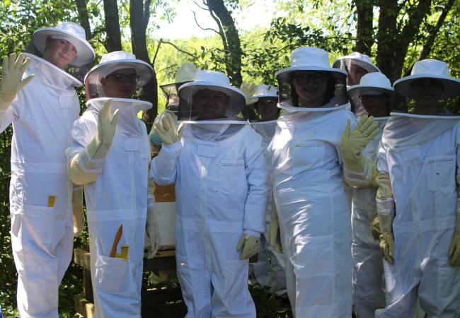 Children in beekeeper suits