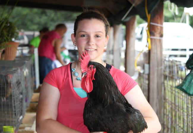 Girl holding chicken
