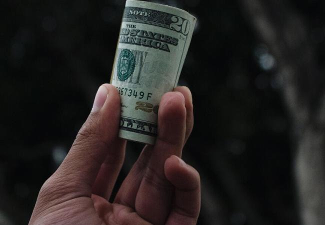 hand holding $20 bill