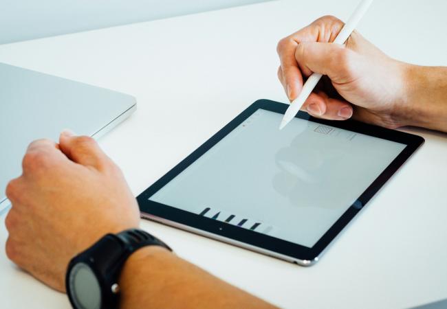 Person using a tablet with a digital pen