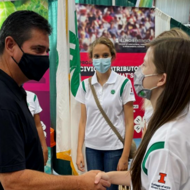 Girl shaking hands with man