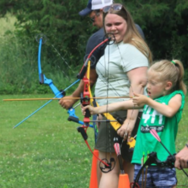 girl shooting bow and arrow