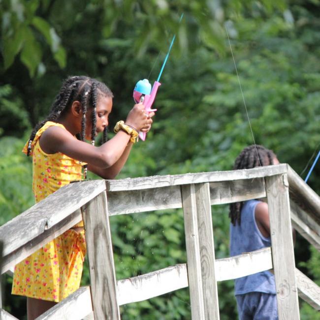 girls fishing off dock