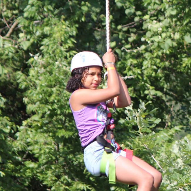 girl riding zipline