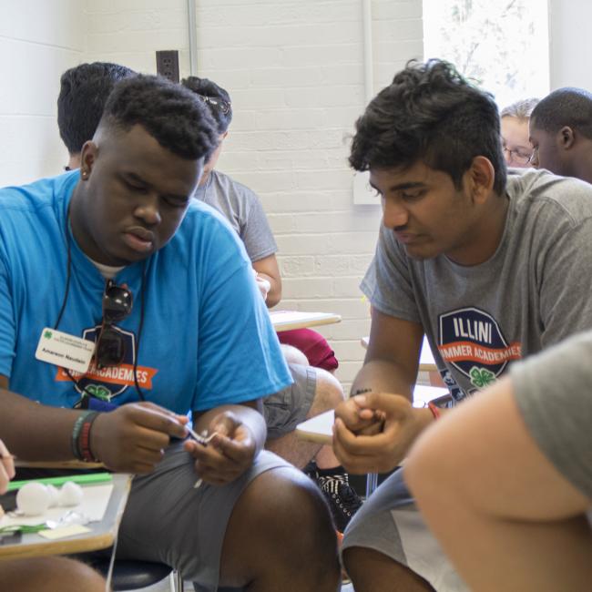 two youth looking at a project