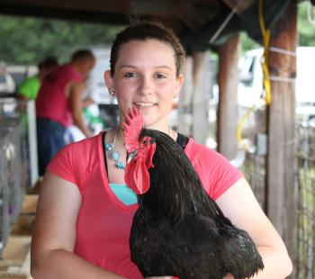 Girl holding chicken