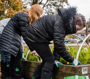 2 girls gardening in raised bed