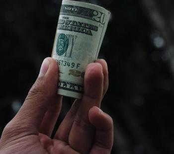 hand holding $20 bill