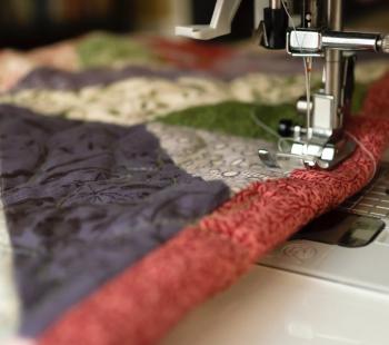 needle sewing a quilt