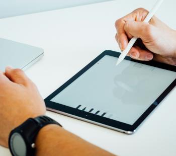 Person using a tablet with a digital pen