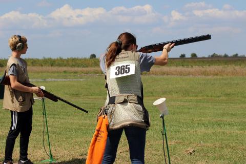 woman shooting shotgun in sporting event