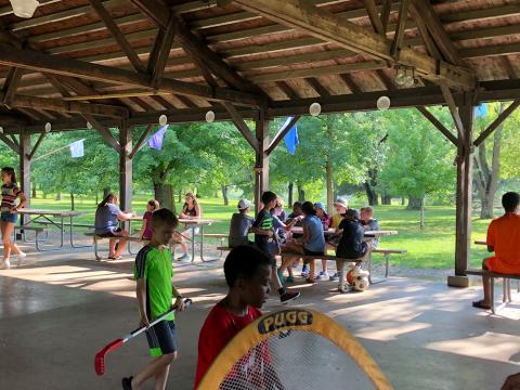 camp pavilion with picnic tables