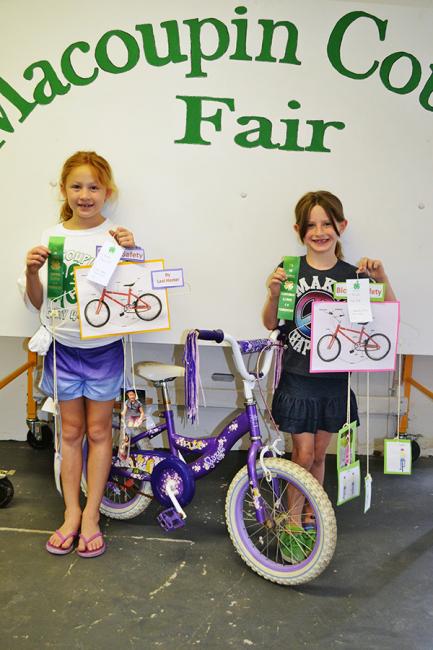 2 girls with their bicycles and projects