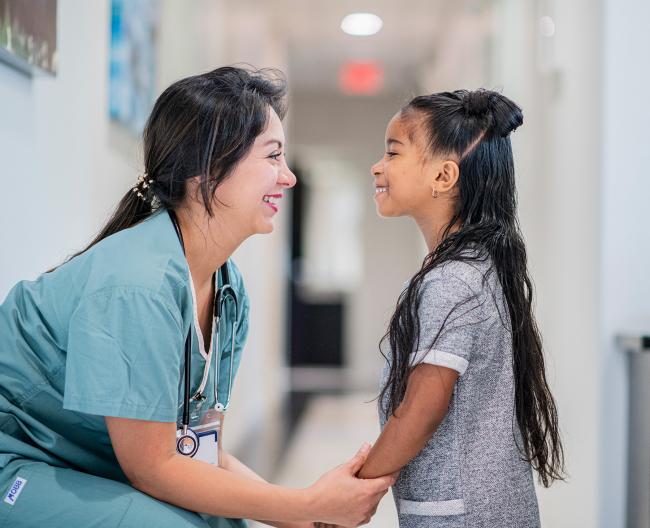 doctor smiling at little girl