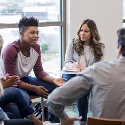 teenage boy speaking to group