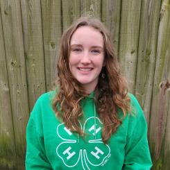 Girl with curly hair in green sweatshirt